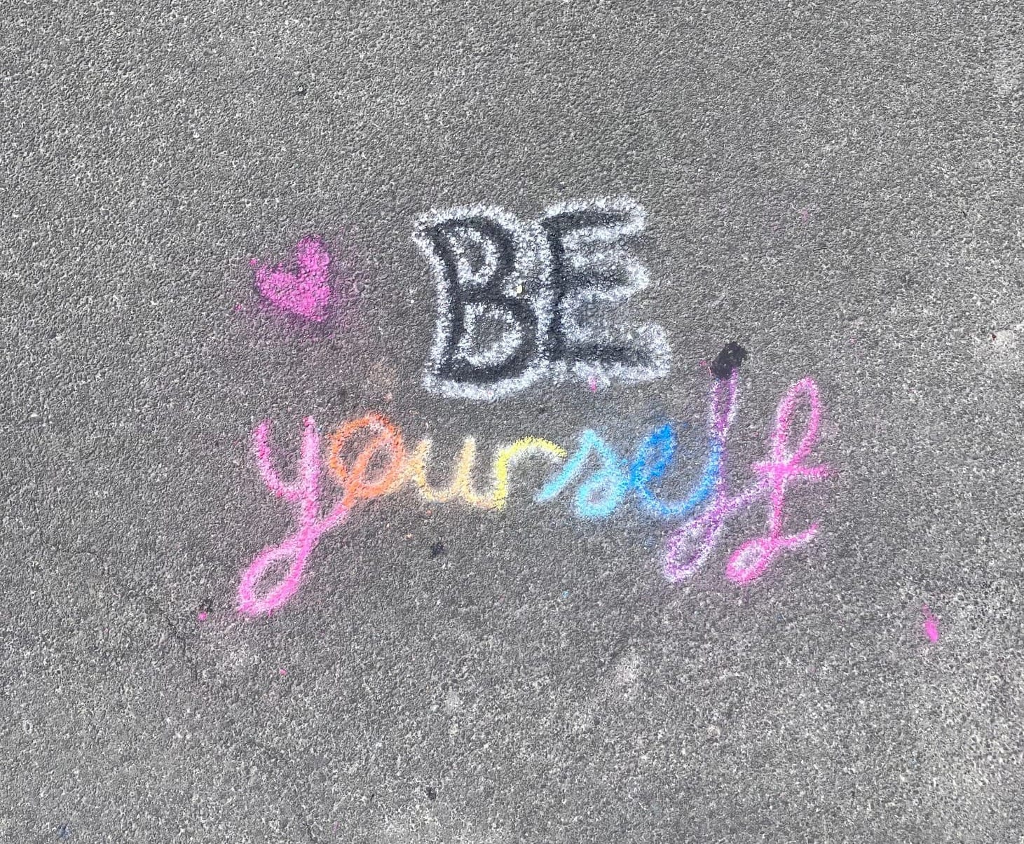 The words "BE yourself", the second word rendered in rainbow letters.