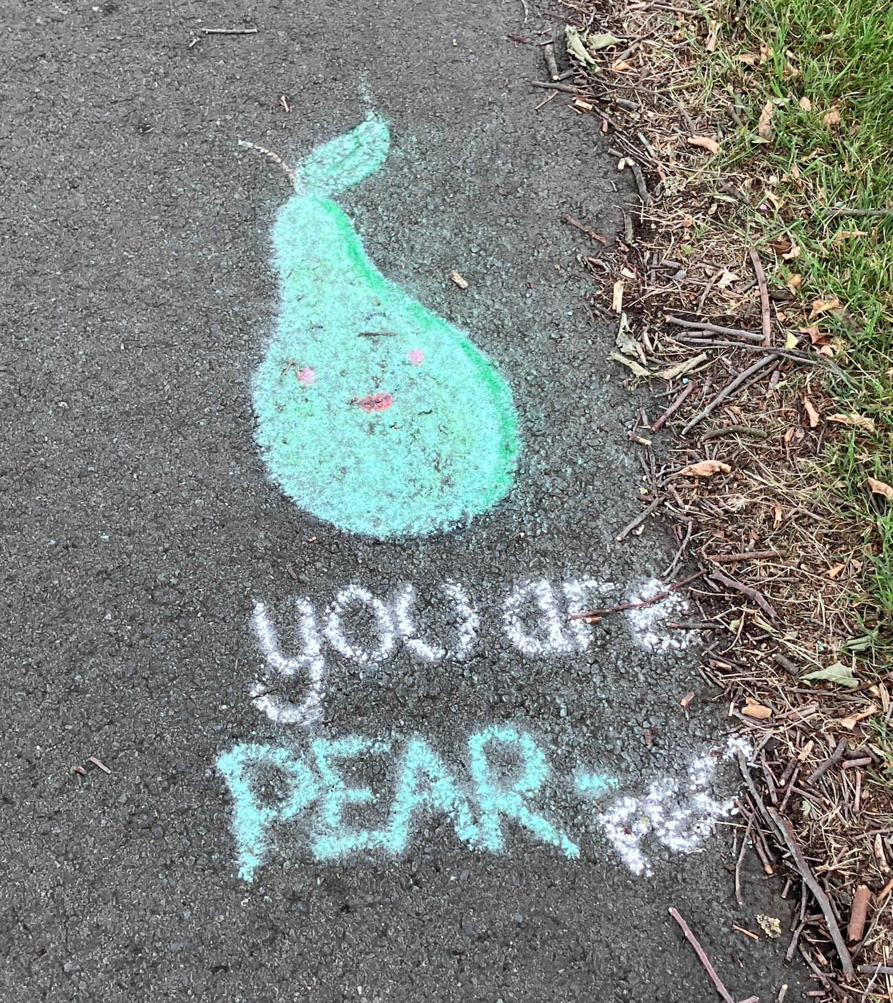 A slightly smudged green chalk pear with a feminine face and the words "you are PEAR-FECT".