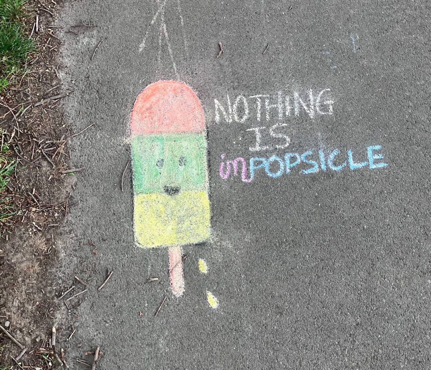 Chalk drawing of a red, green and yellow popsicle with the words "Nothing is impopsicle".