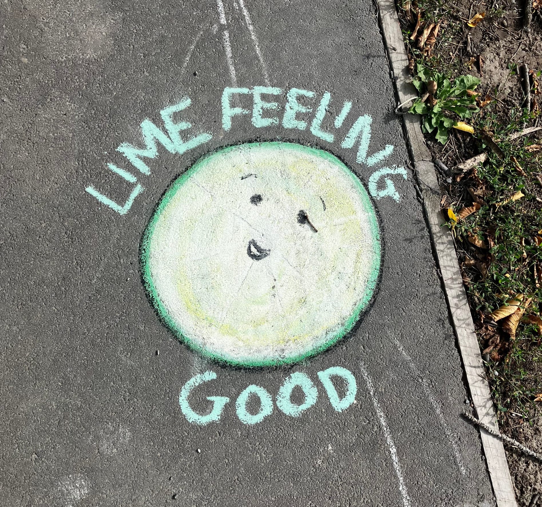 Chalk drawing of a cut lime with green text that says "Lime feeling good".